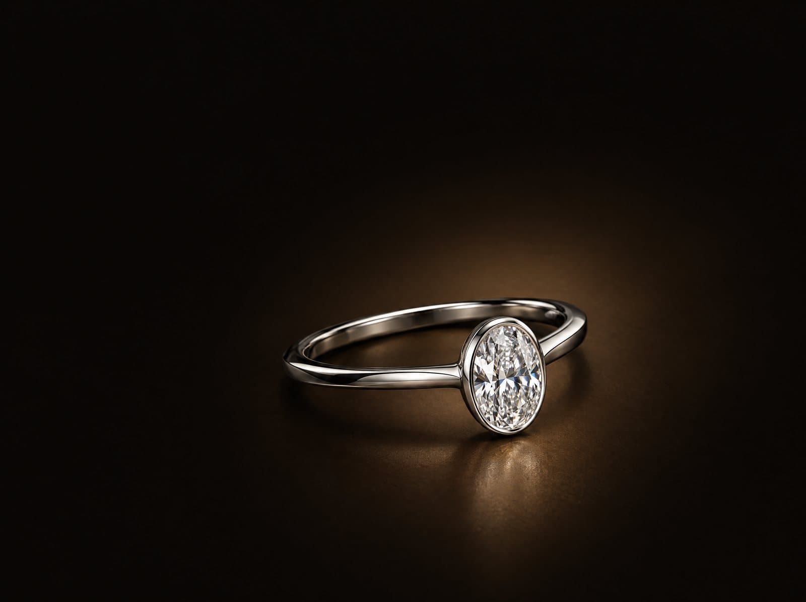 Platinum solitaire with an oval diamond in a low bezel setting